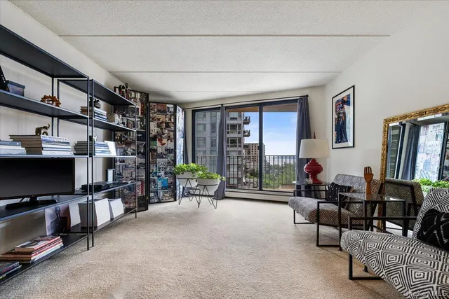 a living room with furniture cabinets and a flat screen tv