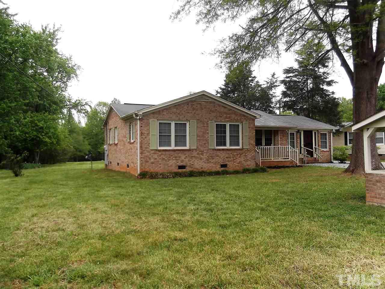 1298 Dick Holeman Road Timberlake, NC 27583 - Photo 14 of 17 a front view of a house with a garden