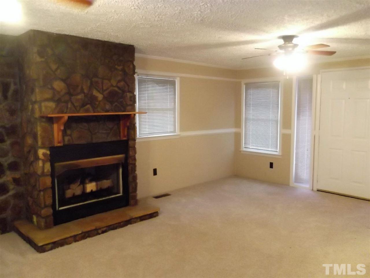 1298 Dick Holeman Road Timberlake, NC 27583 - Photo 8 of 17 a living room with furniture and a fireplace