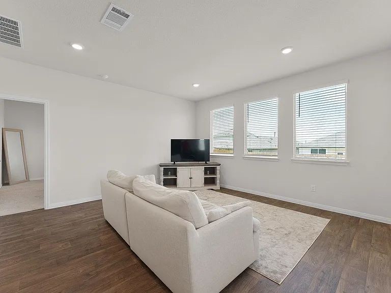 305 Evergreen Sumac Loop Kyle, TX 78640 - Photo 12 of 29 a living room with furniture and a flat screen tv