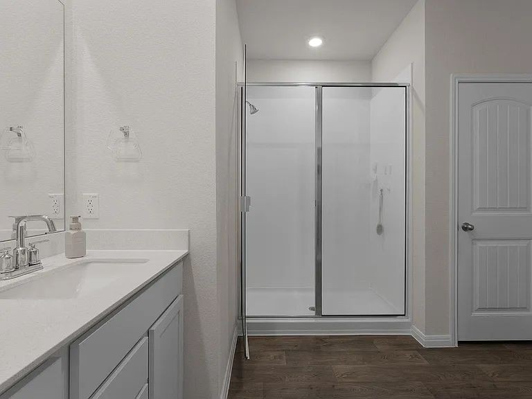 305 Evergreen Sumac Loop Kyle, TX 78640 - Photo 14 of 29 a bathroom with a shower sink and vanity