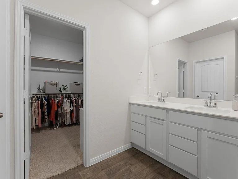 305 Evergreen Sumac Loop Kyle, TX 78640 - Photo 15 of 29 a bathroom with a double vanity sink and a mirror