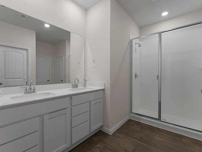 305 Evergreen Sumac Loop Kyle, TX 78640 - Photo 16 of 29 a bathroom with double vanity sink and mirror