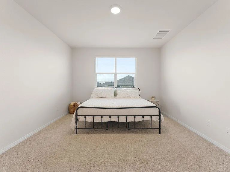 305 Evergreen Sumac Loop Kyle, TX 78640 - Photo 17 of 29 a bedroom with a bed and window