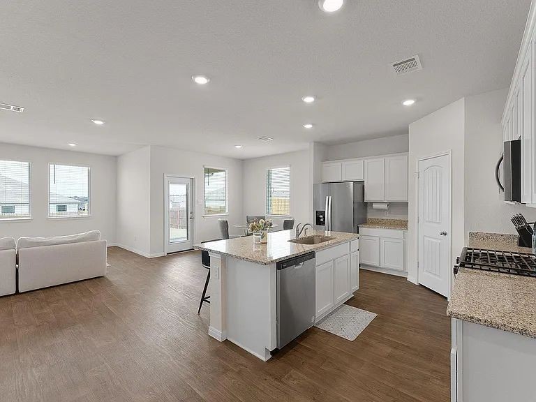 305 Evergreen Sumac Loop Kyle, TX 78640 - Photo 23 of 29 a kitchen with stainless steel appliances granite countertop a stove and a refrigerator