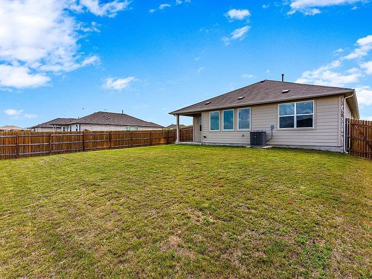 305 Evergreen Sumac Loop Kyle, TX 78640 - Photo 26 of 29 a front view of a house with a yard