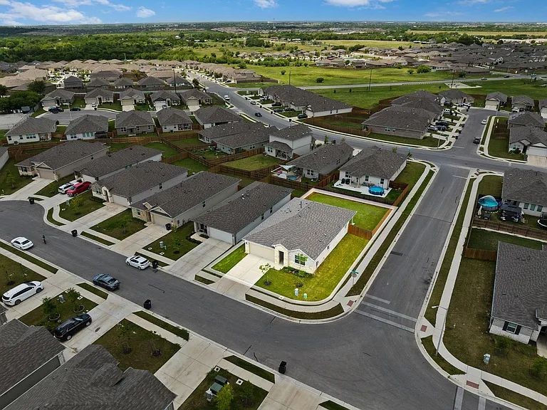 305 Evergreen Sumac Loop Kyle, TX 78640 - Photo 4 of 29 an aerial view of residential houses with outdoor space