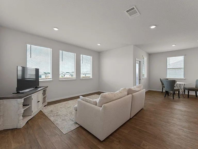 305 Evergreen Sumac Loop Kyle, TX 78640 - Photo 10 of 29 a living room with furniture and a flat screen tv