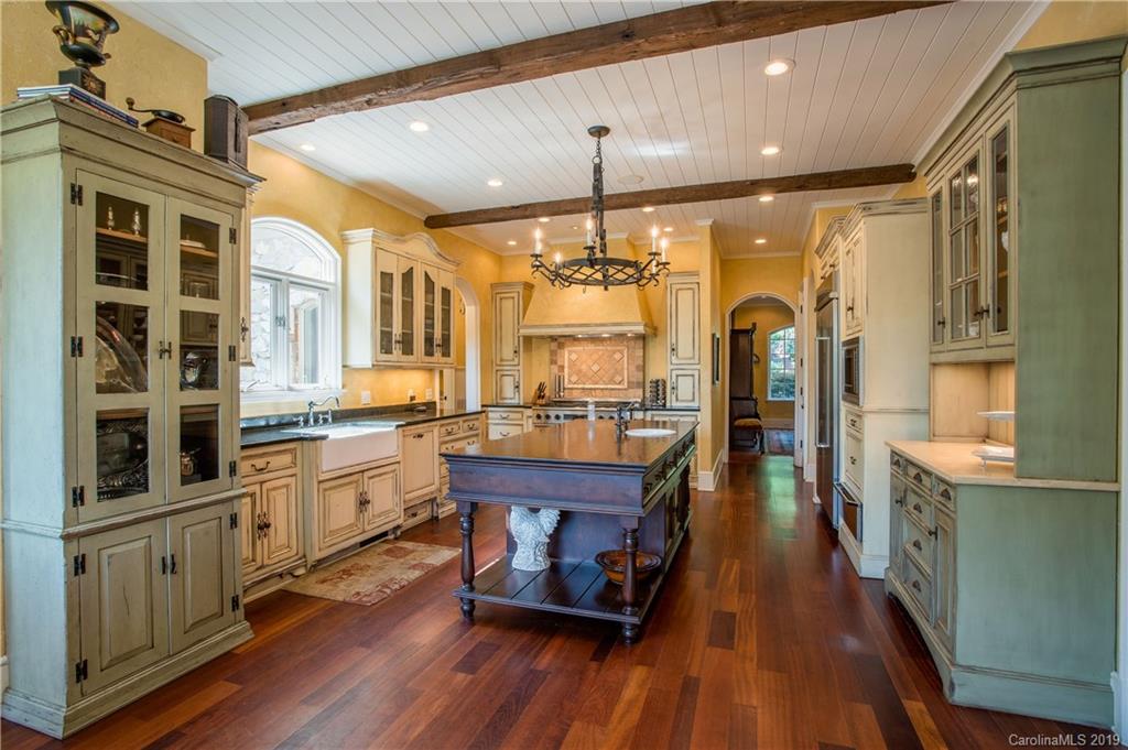 243 Trail Ridge Road Rutherfordton, NC 28139 - Photo 16 of 45 a open kitchen with stainless steel appliances granite countertop a lot of counter space and wooden floors