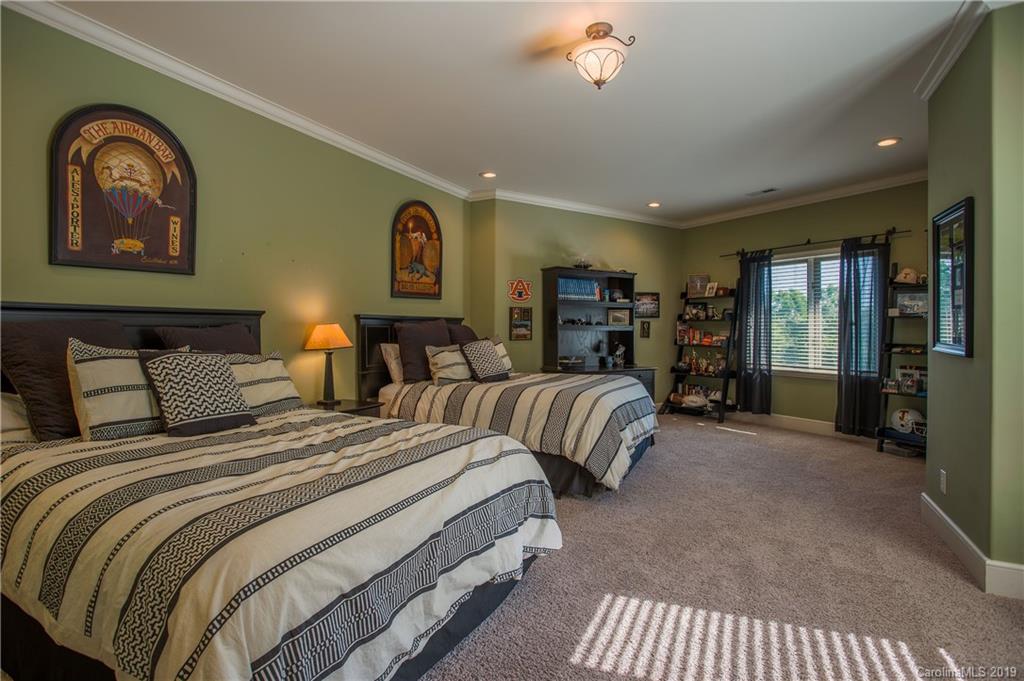 243 Trail Ridge Road Rutherfordton, NC 28139 - Photo 32 of 45 a spacious bedroom with two beds and a large mirror