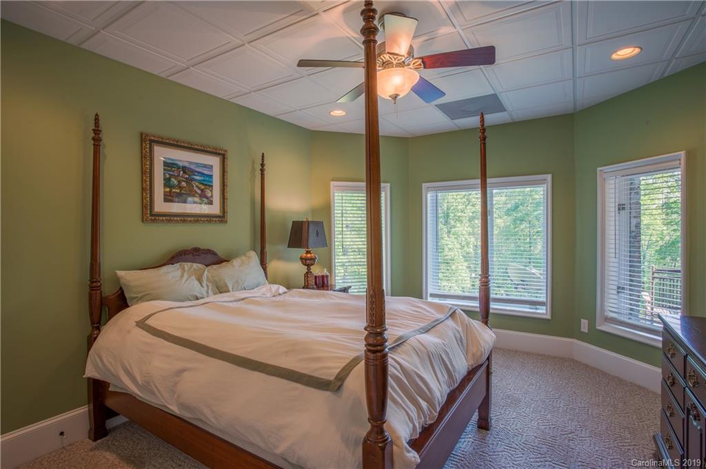 243 Trail Ridge Road Rutherfordton, NC 28139 - Photo 41 of 45 a bedroom with a bed and a chandelier