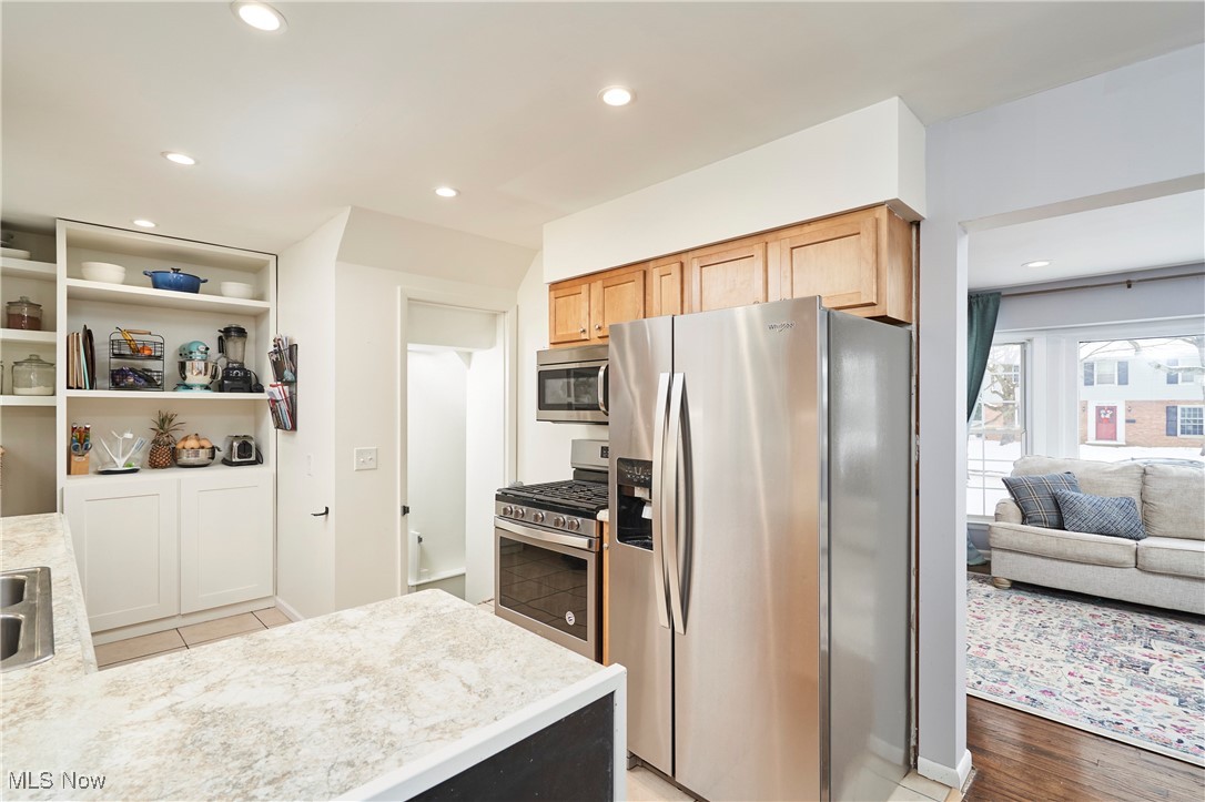 1847 Stabler Road Akron, OH 44313 - Photo 7 of 26 Kitchen featuring light stone countertops, stainless steel appliances, and light hardwood / wood-style floors