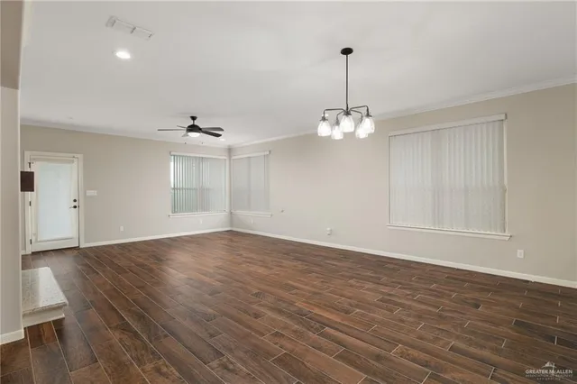 a view of a room with wooden floor staircase and a chandelier