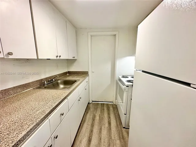 a kitchen with a stove top oven and sink