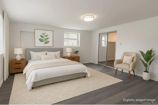 a bedroom with a bed and a potted plant on table