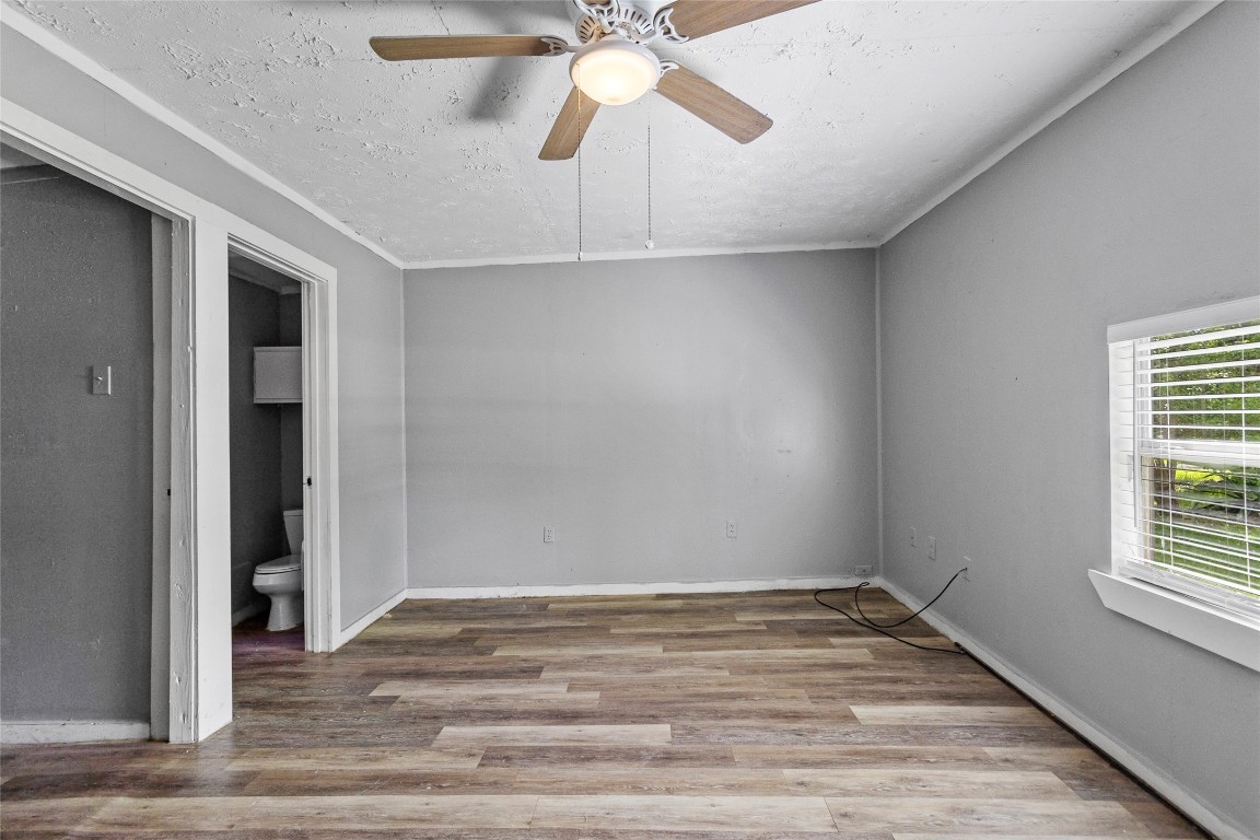 8 Jackson Road Huntsville, TX 77320 - Photo 11 of 26 wooden floor in an empty room with a window