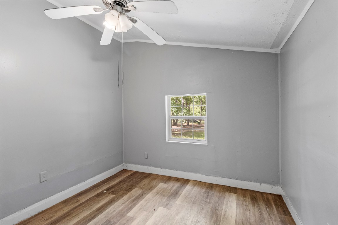 8 Jackson Road Huntsville, TX 77320 - Photo 15 of 26 an empty room with a window and a fan