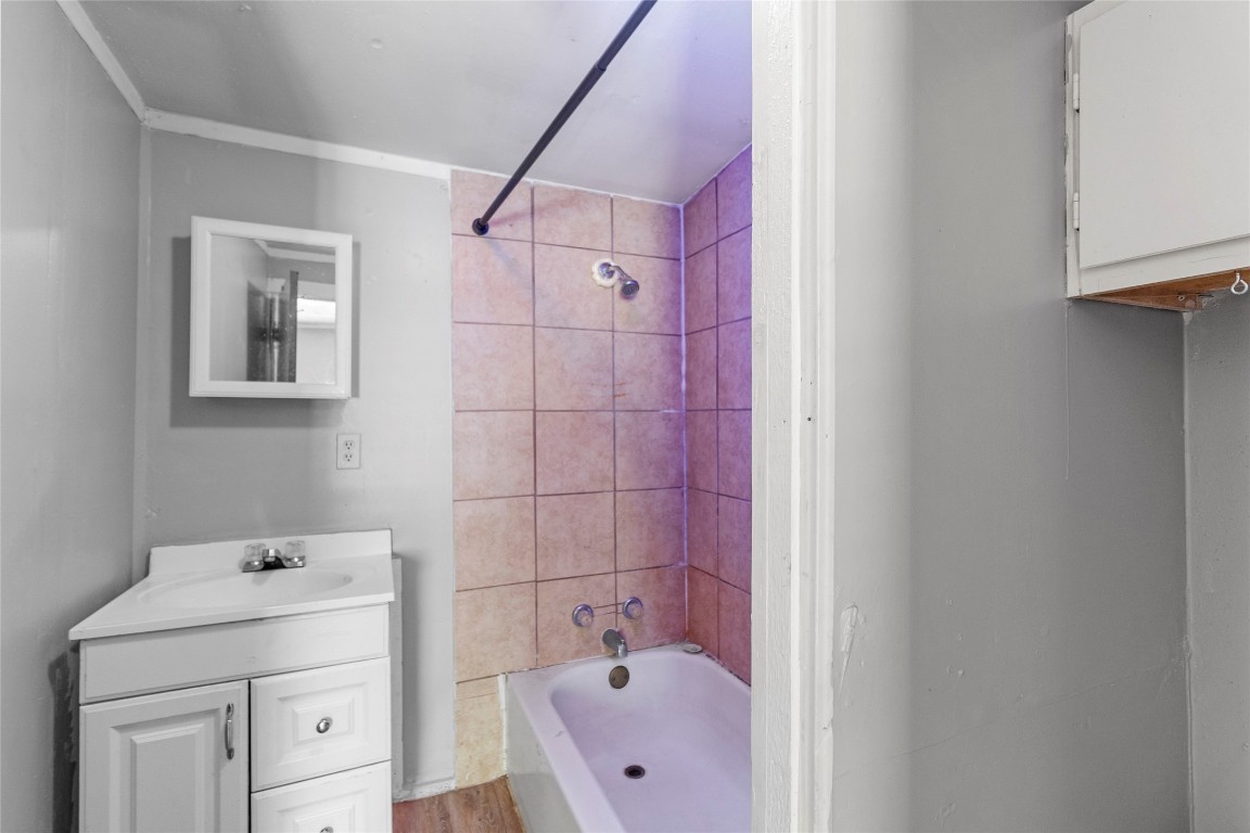 8 Jackson Road Huntsville, TX 77320 - Photo 9 of 26 a bathroom with a bathtub sink vanity and mirror