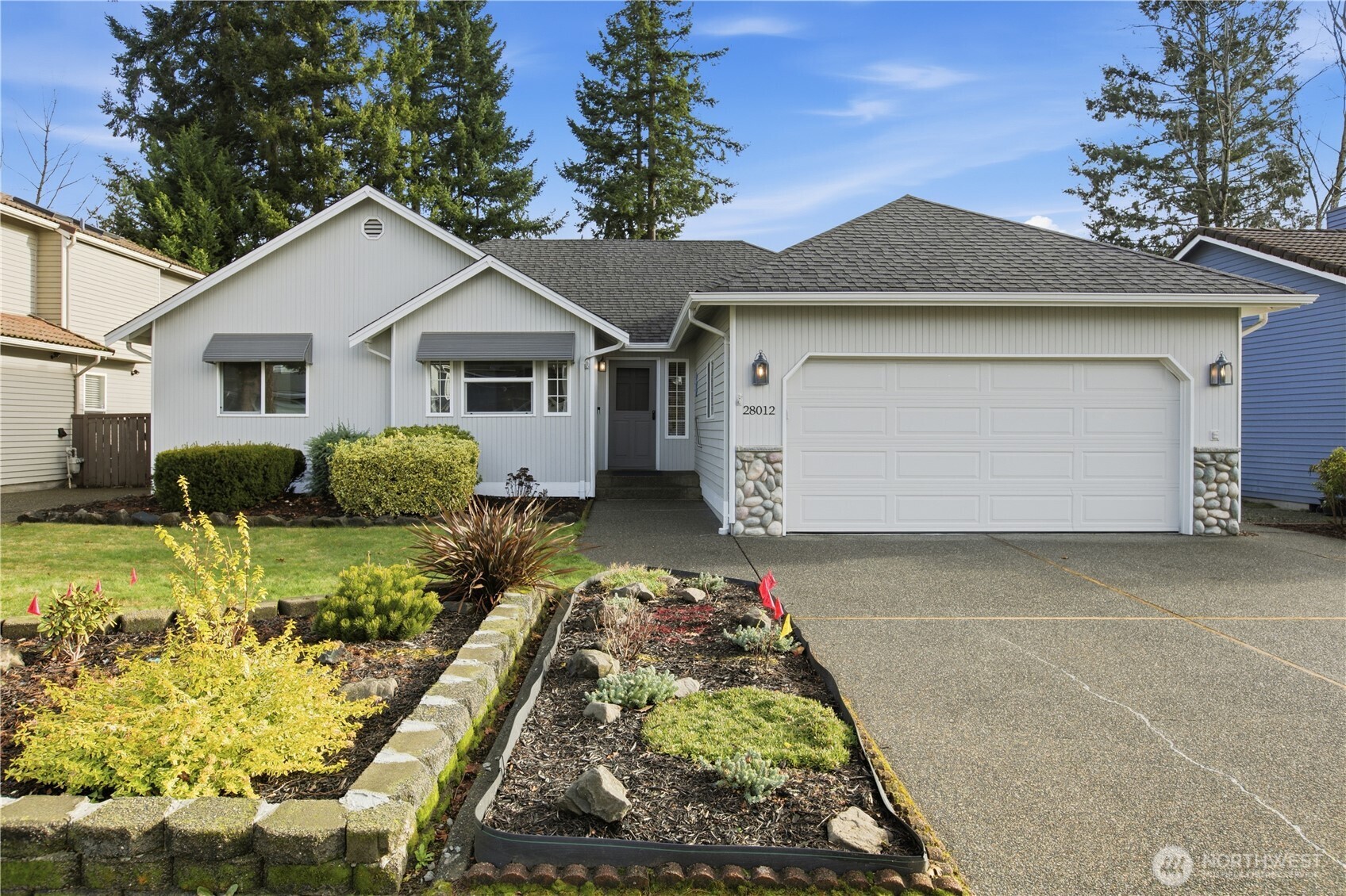 a front view of a house with a yard and garage