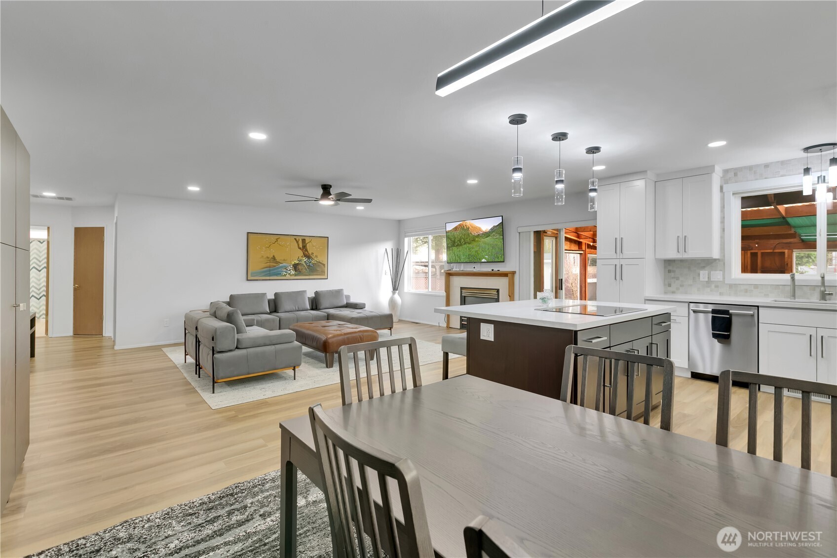 28012 236th Avenue Southeast Maple Valley, WA 98038 - Photo 12 of 39 a kitchen with stainless steel appliances kitchen island granite countertop a dining table chairs and granite counter tops