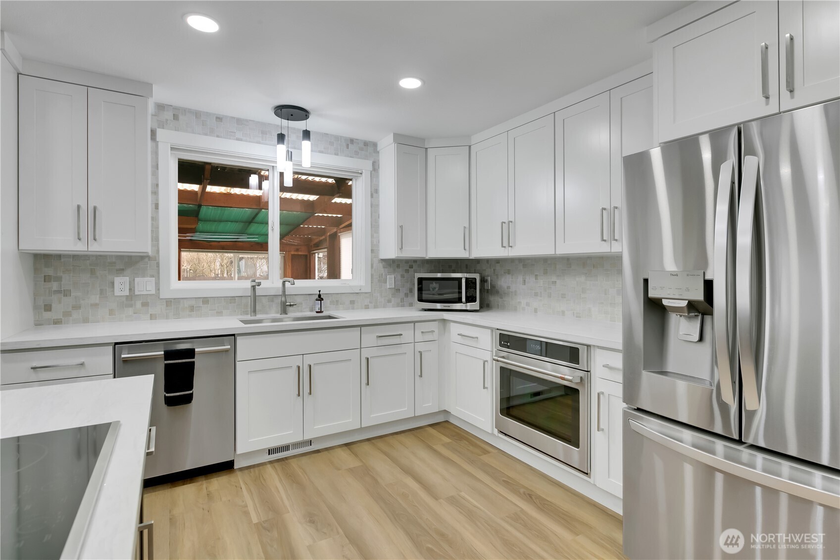 28012 236th Avenue Southeast Maple Valley, WA 98038 - Photo 15 of 39 a kitchen with granite countertop stainless steel appliances and wooden cabinets
