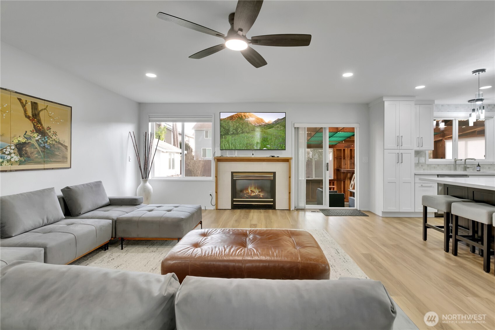 28012 236th Avenue Southeast Maple Valley, WA 98038 - Photo 6 of 39 a living room with furniture a flat screen tv and a fireplace
