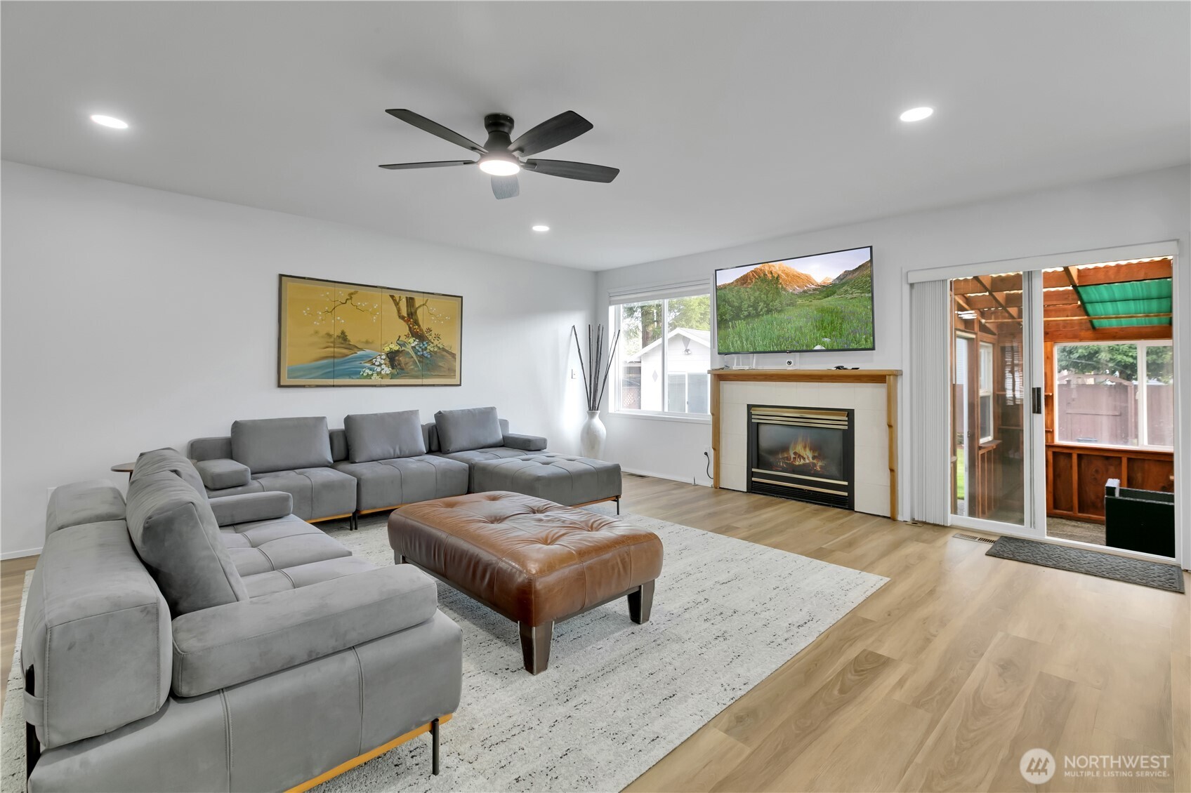 28012 236th Avenue Southeast Maple Valley, WA 98038 - Photo 7 of 39 a living room with furniture a fireplace and a flat screen tv