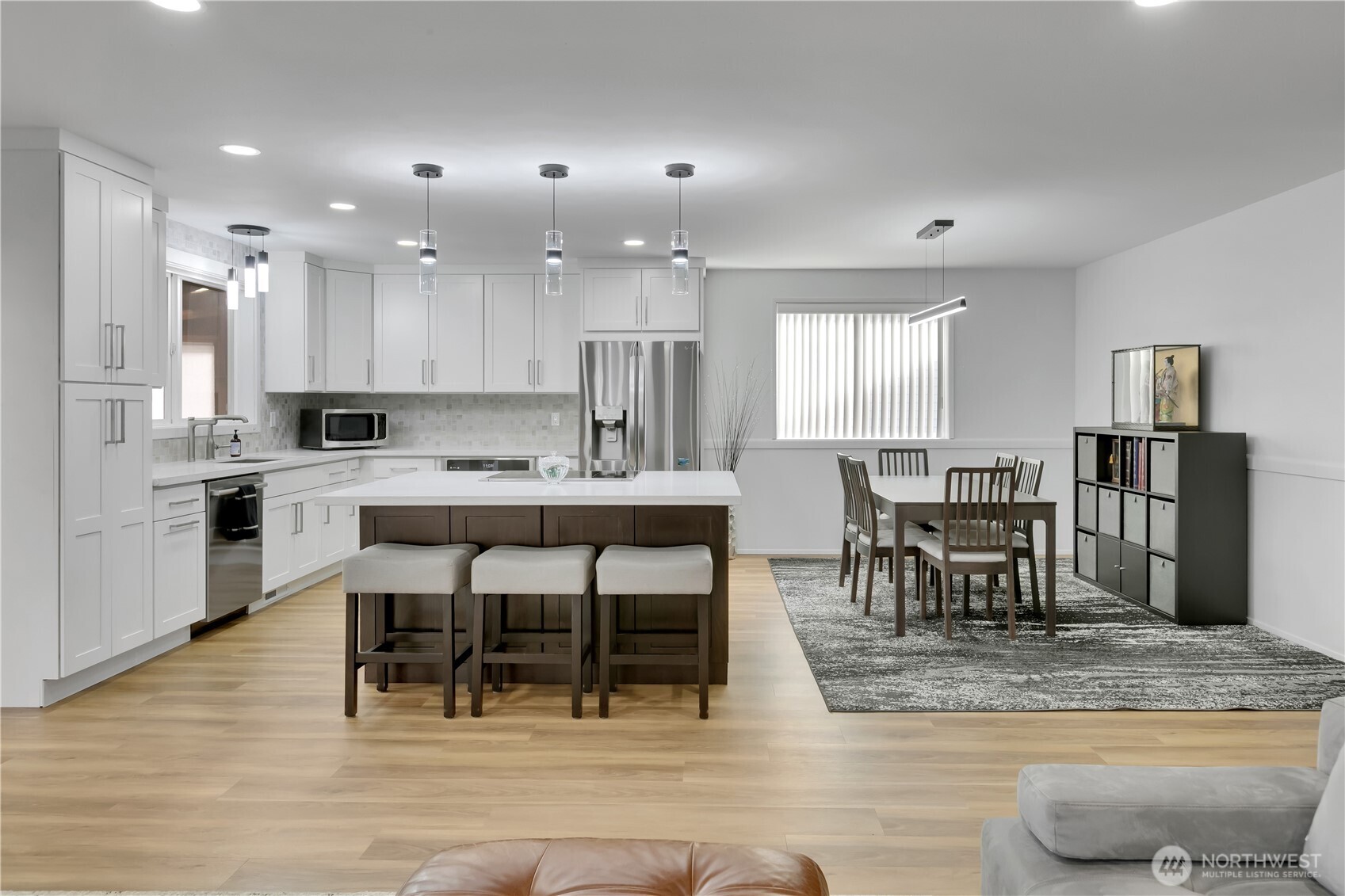 28012 236th Avenue Southeast Maple Valley, WA 98038 - Photo 9 of 39 a kitchen with stainless steel appliances granite countertop a table and chairs in it
