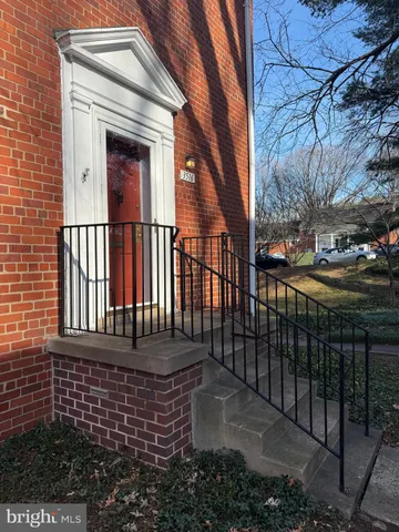 a view of a brick house with a small yard