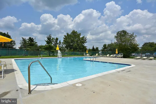 a view of a swimming pool with a yard