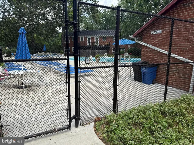 a view of a park with iron fence