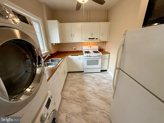 a kitchen with a sink a stove and cabinets