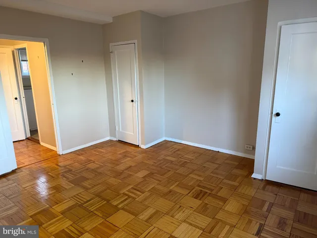 a view of an empty room and wooden floor