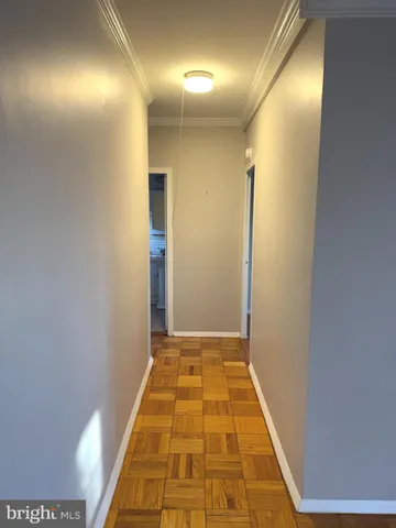 a view of hallway with wooden floor