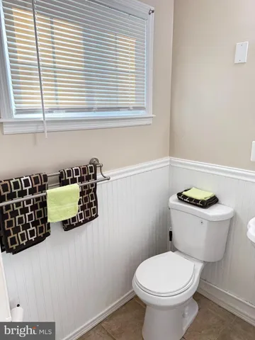 a bathroom with a toilet a sink and a window