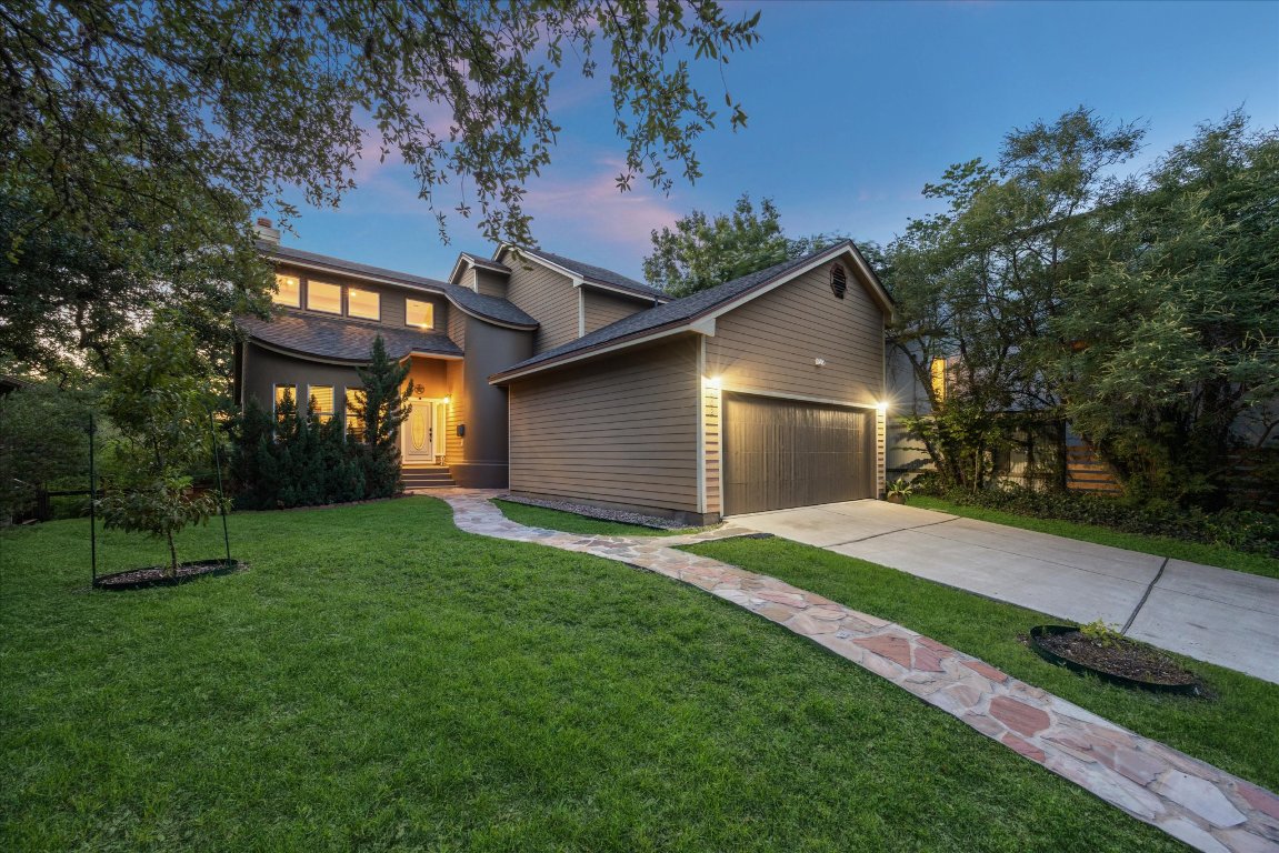 602 Jessie Street Austin, TX 78704 - Photo 2 of 12 a front view of a house with a yard and garage
