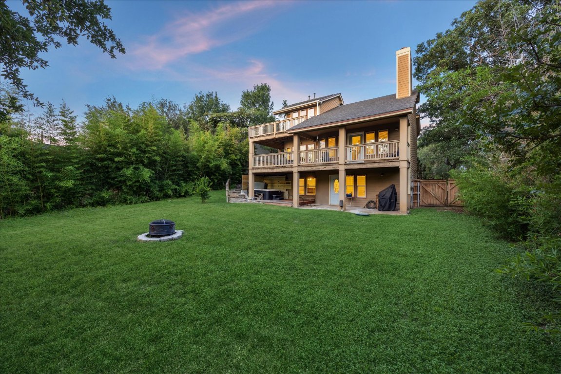 602 Jessie Street Austin, TX 78704 - Photo 10 of 12 a view of a brick house with a big yard and large trees