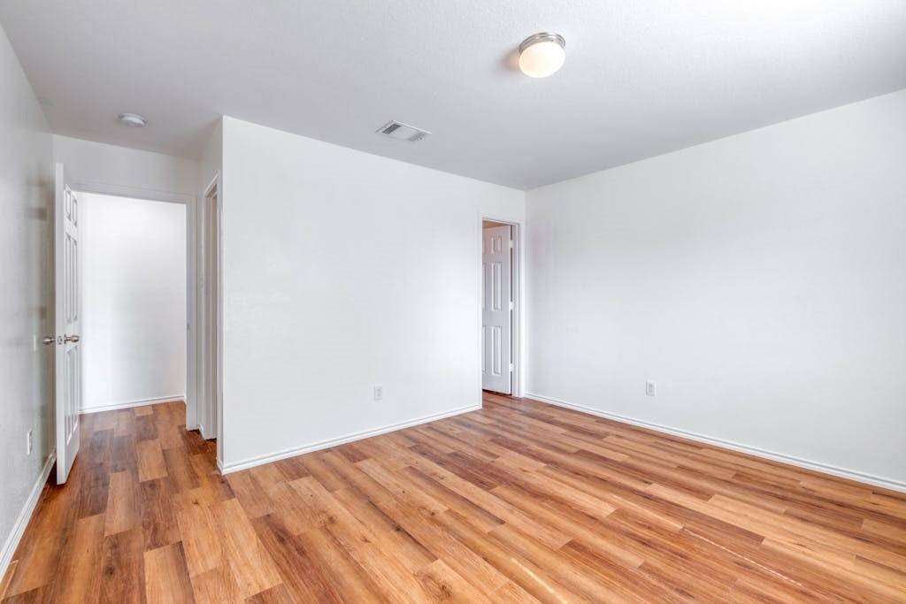 3415 Crownover Street Austin, TX 78725 - Photo 6 of 13 Empty room with light wood-style floors and baseboards