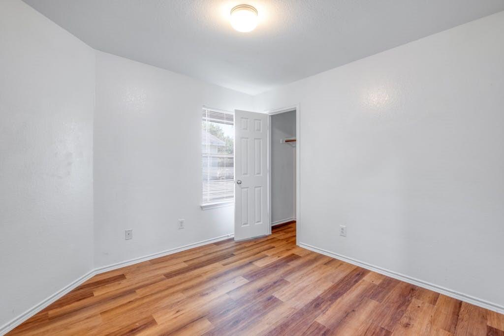 3415 Crownover Street Austin, TX 78725 - Photo 9 of 13 Unfurnished room with light wood-style flooring and baseboards
