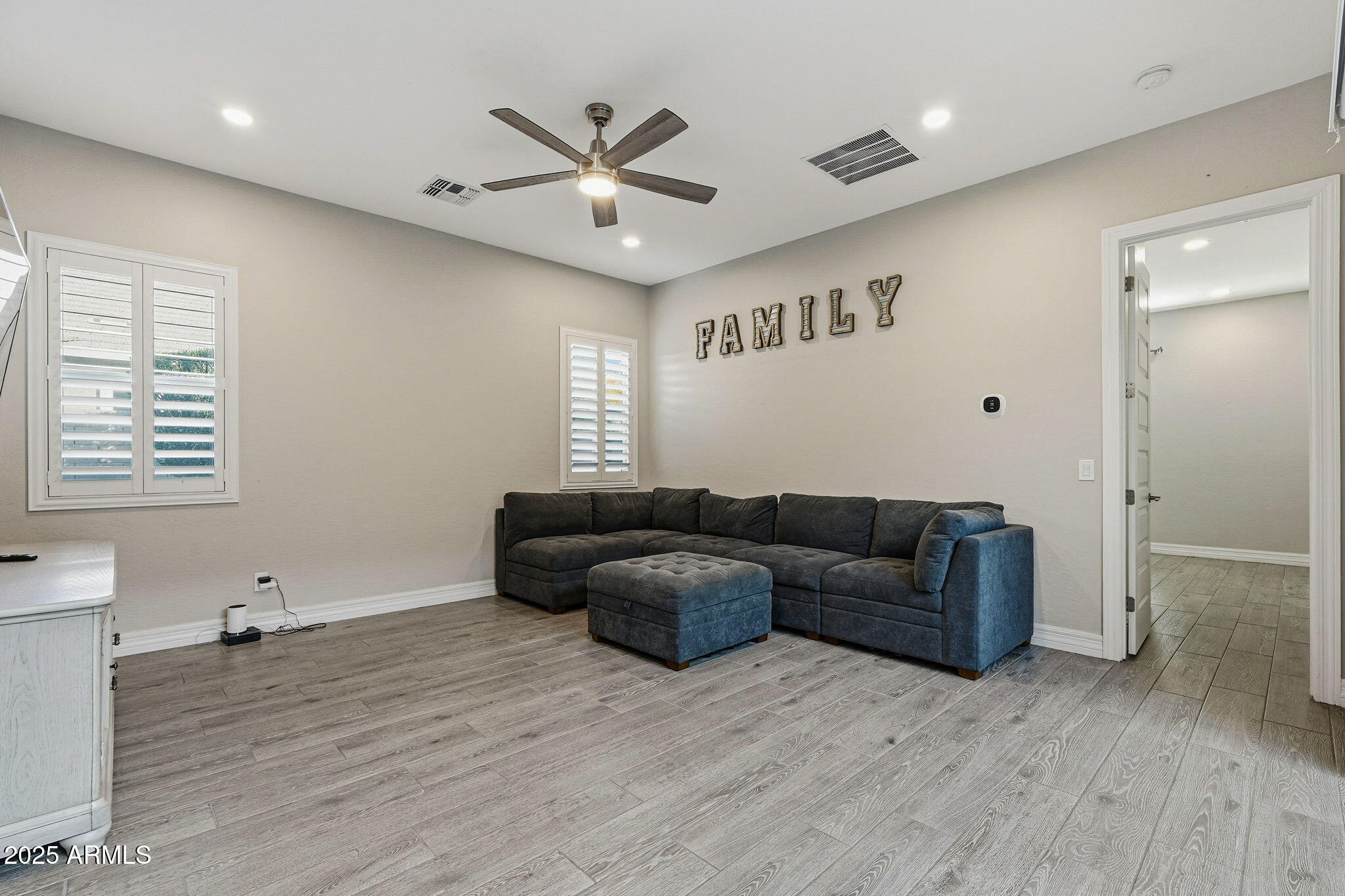 22940 East Camacho Road Queen Creek, AZ 85142 - Photo 15 of 68 a living room with furniture and a wooden floor