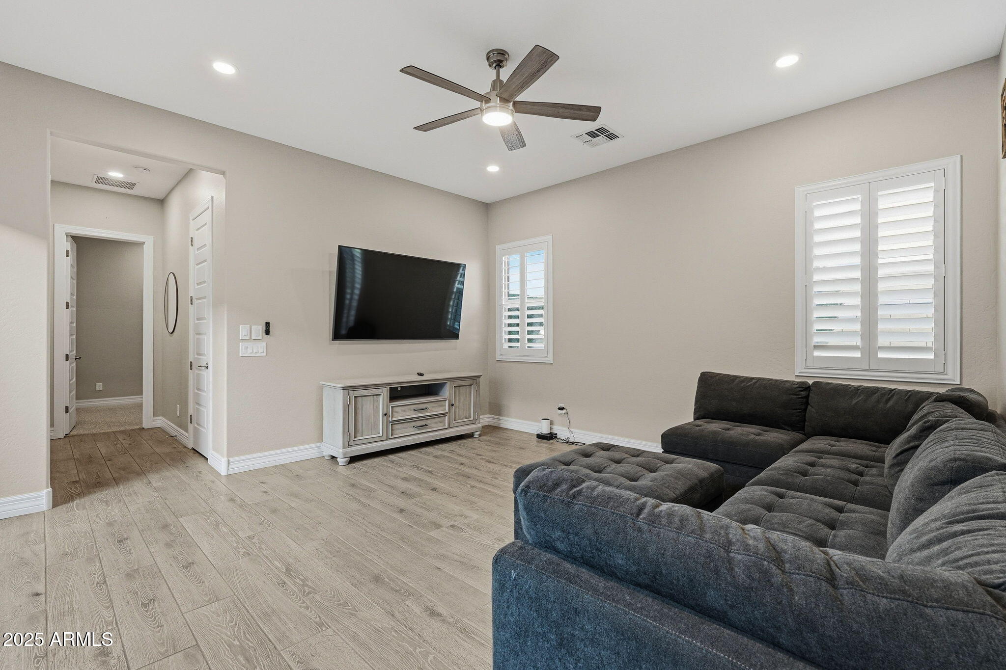 22940 East Camacho Road Queen Creek, AZ 85142 - Photo 16 of 68 a living room with furniture and a flat screen tv