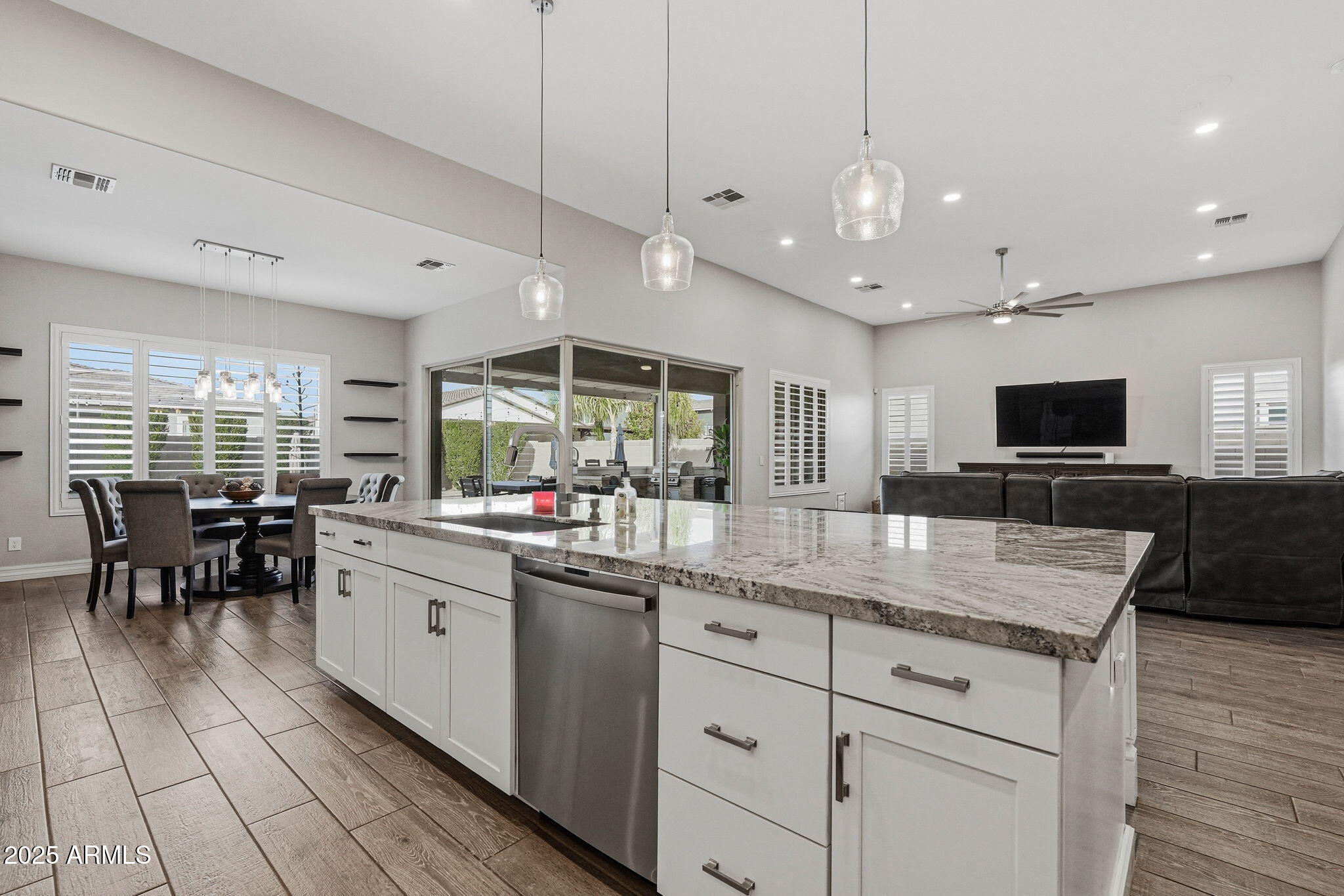 22940 East Camacho Road Queen Creek, AZ 85142 - Photo 21 of 68 a kitchen with stainless steel appliances kitchen island granite countertop a sink and a stove