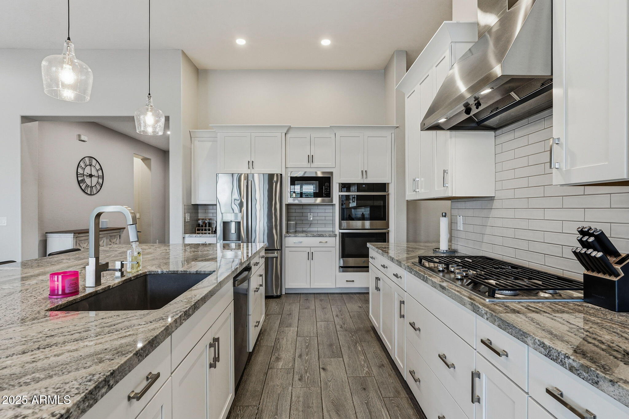 22940 East Camacho Road Queen Creek, AZ 85142 - Photo 22 of 68 a kitchen with stainless steel appliances granite countertop a sink stove and refrigerator