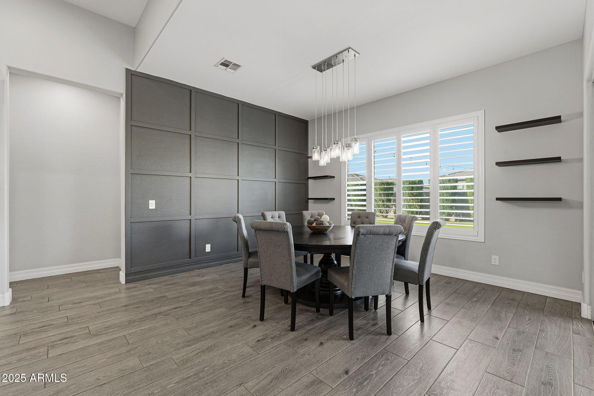 22940 East Camacho Road Queen Creek, AZ 85142 - Photo 26 of 68 a view of a dining room with furniture and wooden floor