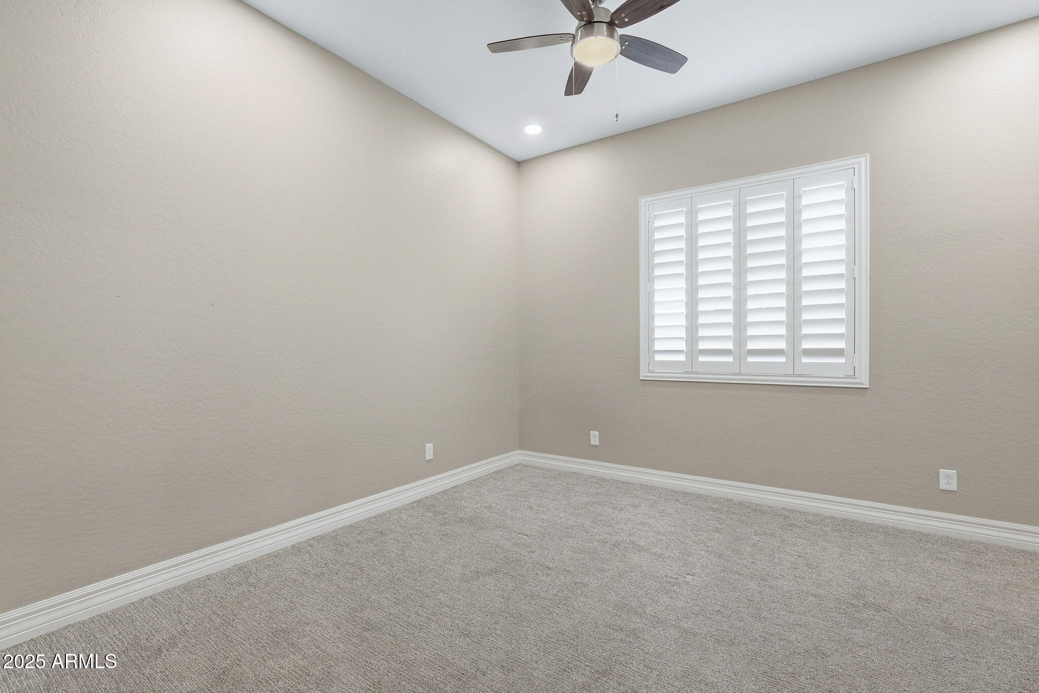 22940 East Camacho Road Queen Creek, AZ 85142 - Photo 40 of 68 an empty room with a window and a fan