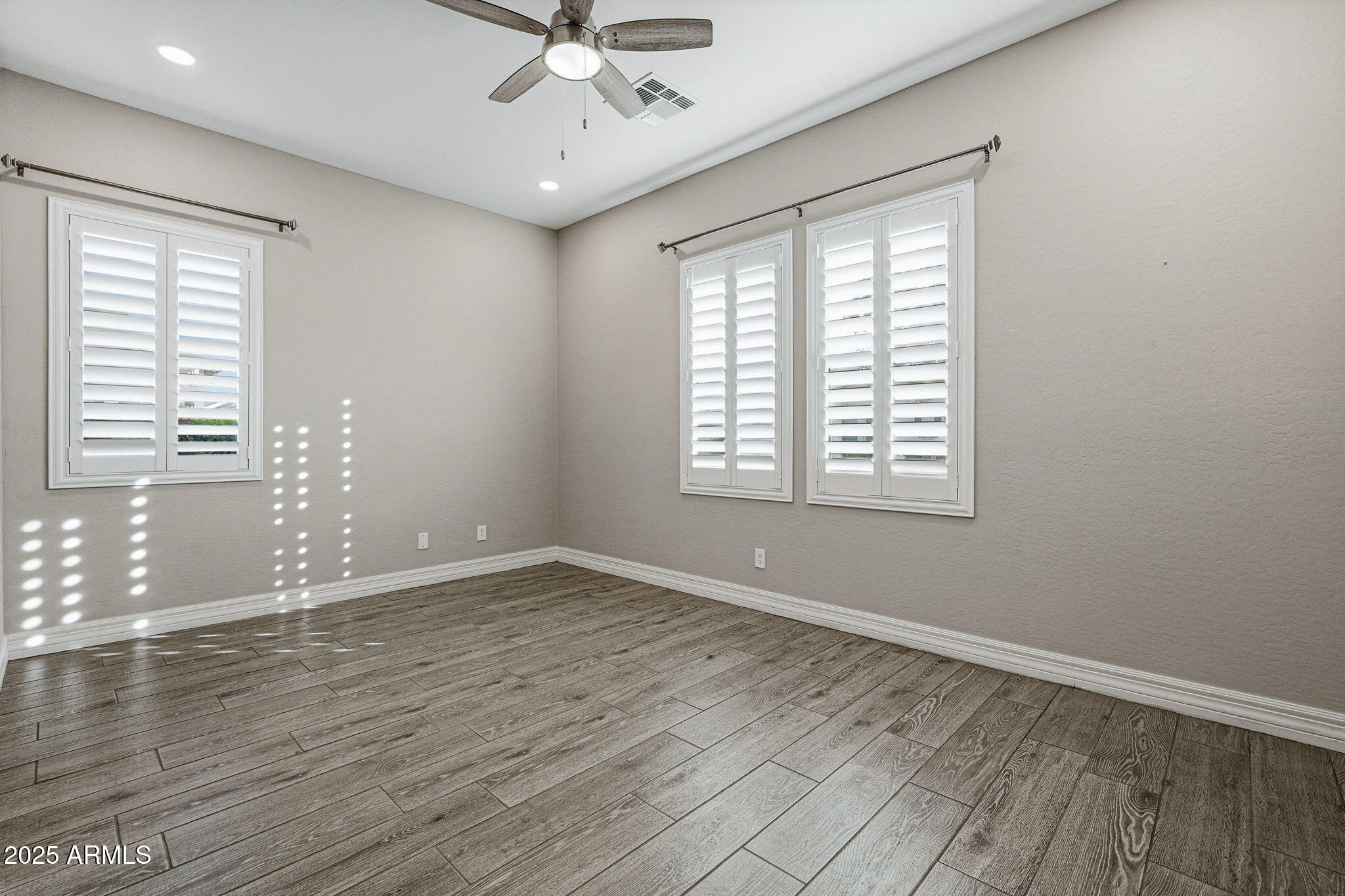 22940 East Camacho Road Queen Creek, AZ 85142 - Photo 42 of 68 a view of an empty room with wooden floor and a window
