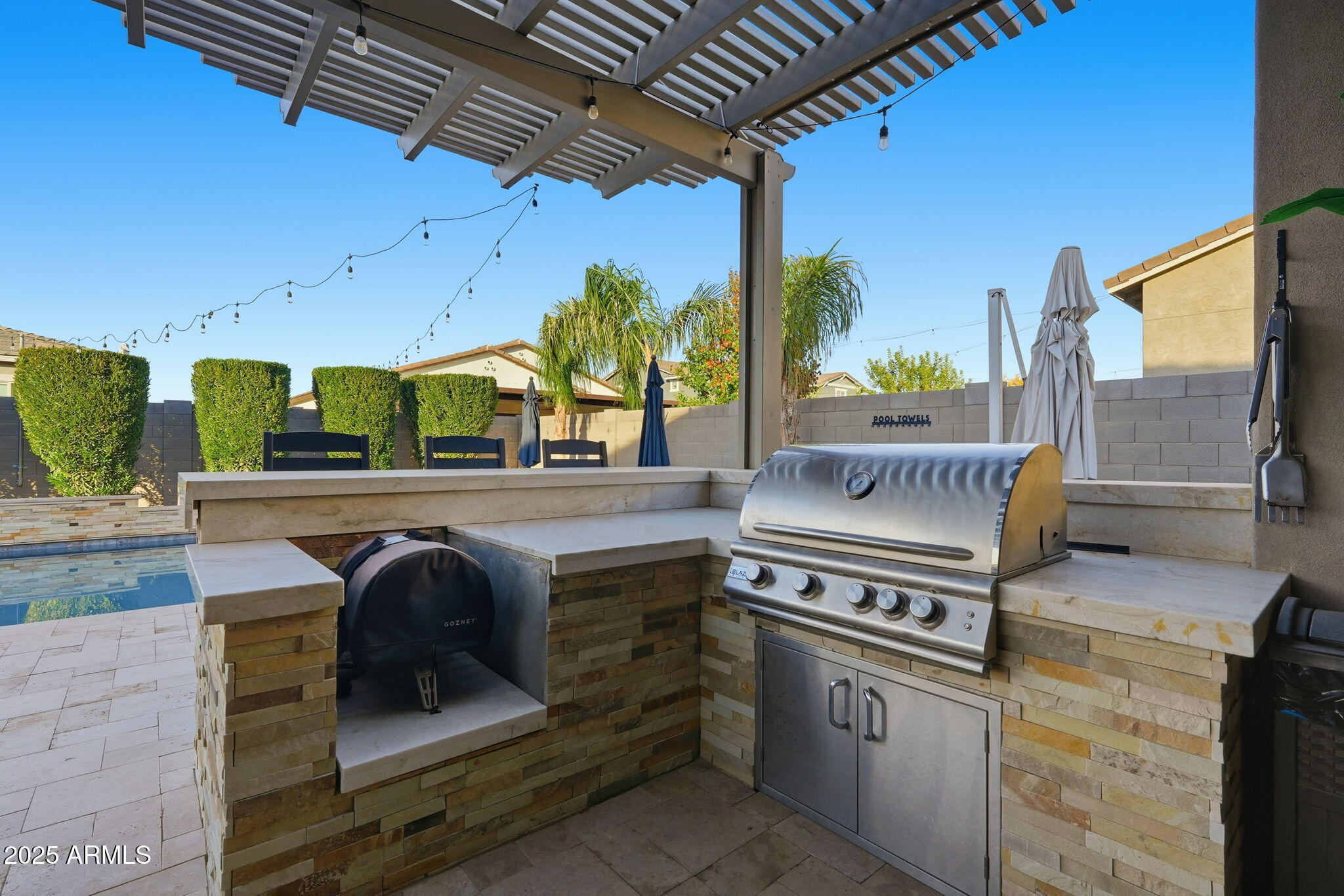 22940 East Camacho Road Queen Creek, AZ 85142 - Photo 54 of 68 a kitchen with stainless steel appliances granite countertop a stove a sink and a microwave