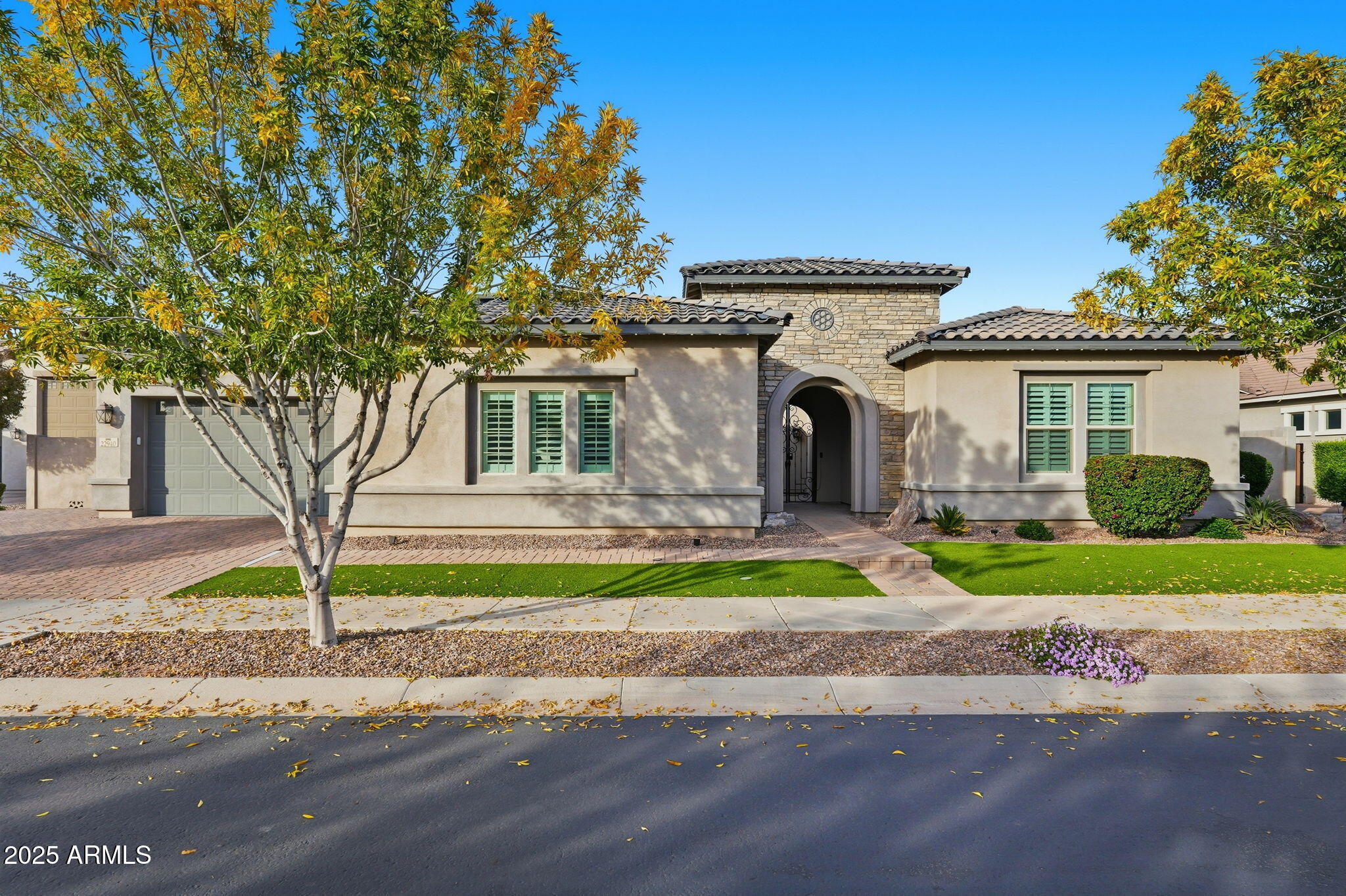 22940 East Camacho Road Queen Creek, AZ 85142 - Photo 7 of 68 a front view of a house with a yard