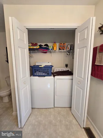 a utility room with cabinets washer and dryer