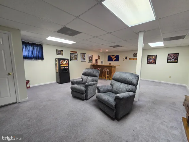 a living room with furniture and a bookshelf